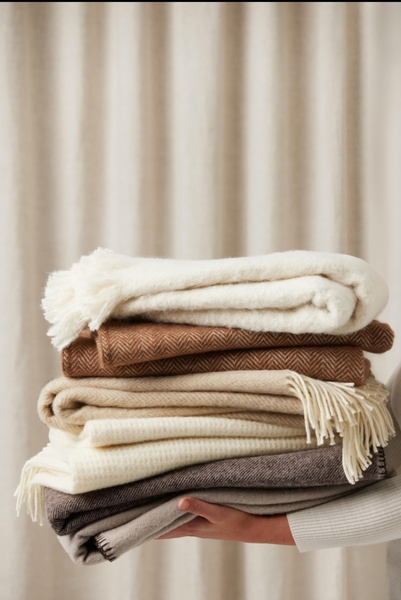 Folded blankets in soft cream and tan