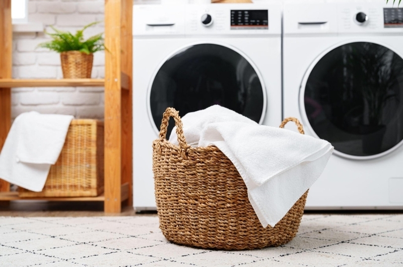 Wicker laundry basket with fresh white linen